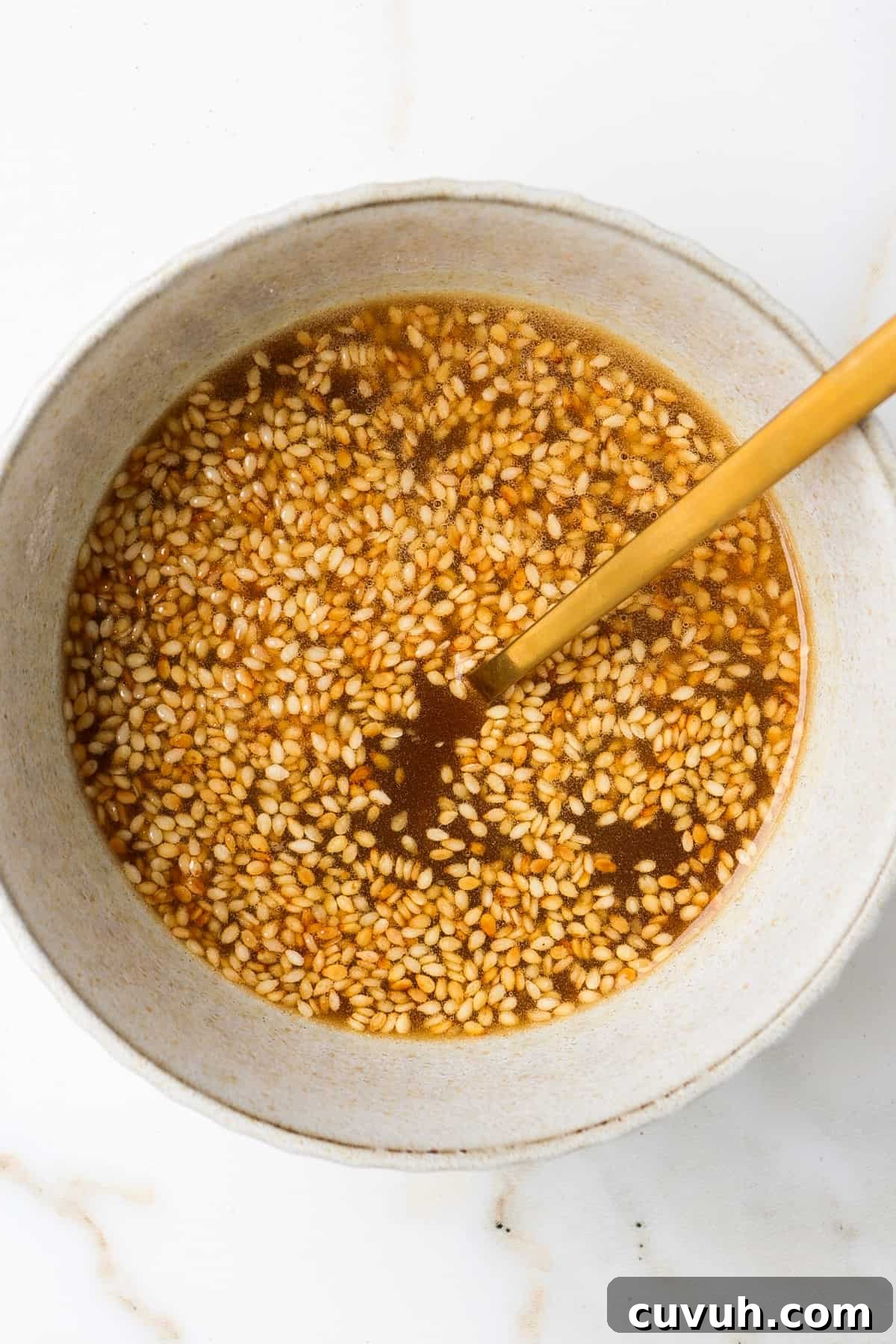 Sesame Carrot and Cucumber Salad with Tangy Dressing 5 Sesame dressing in a bowl.