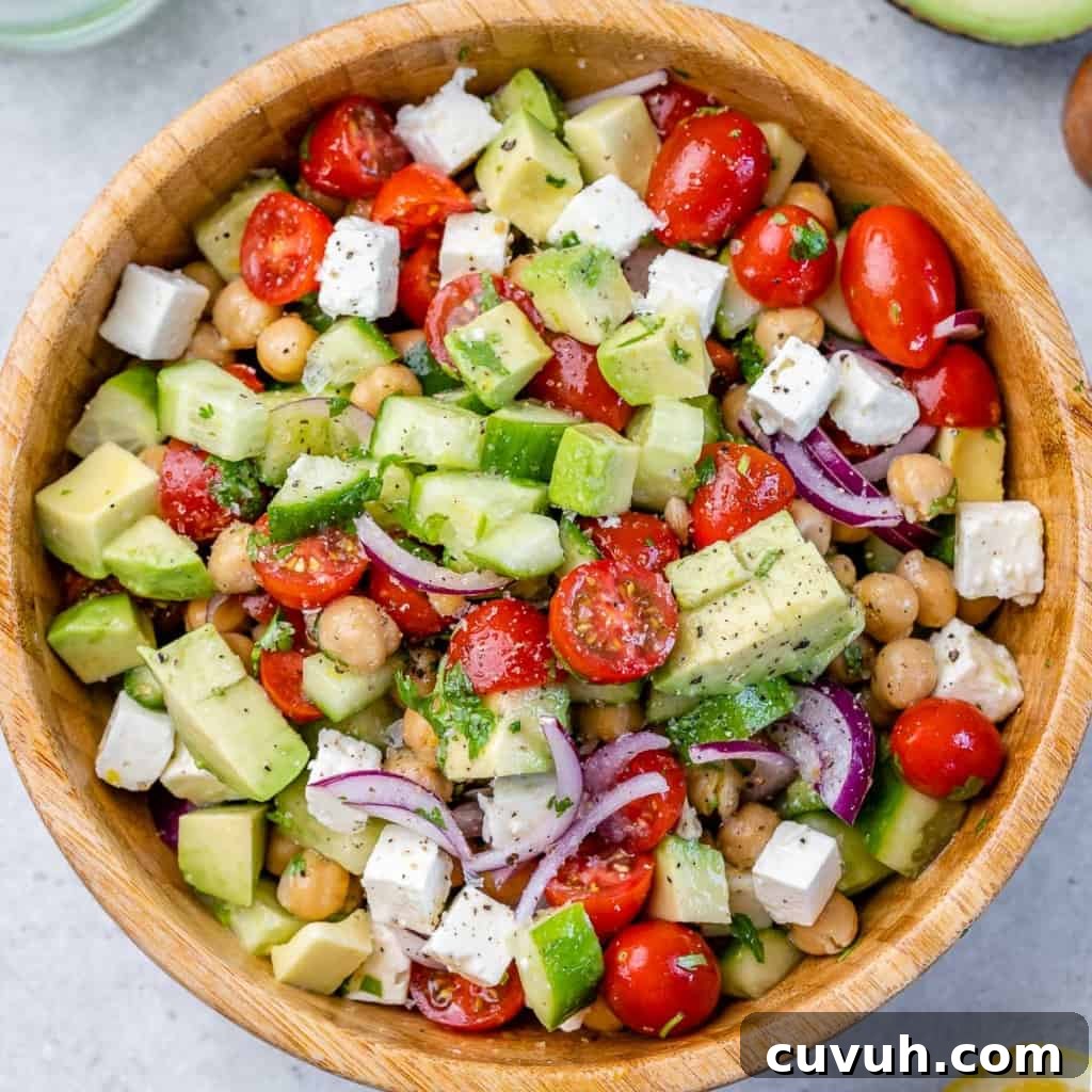 top view chickpea tomato salad in a wooden bowl