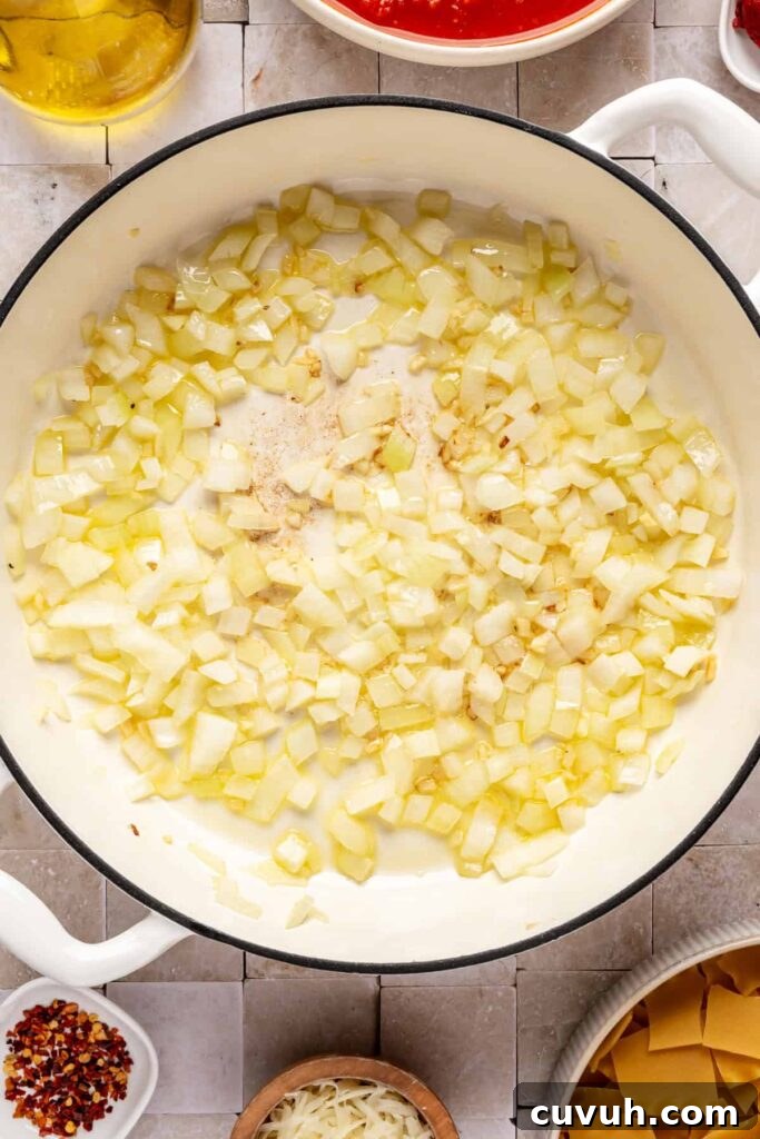 Sautéing aromatic ingredients for lasagna soup including onions and garlic