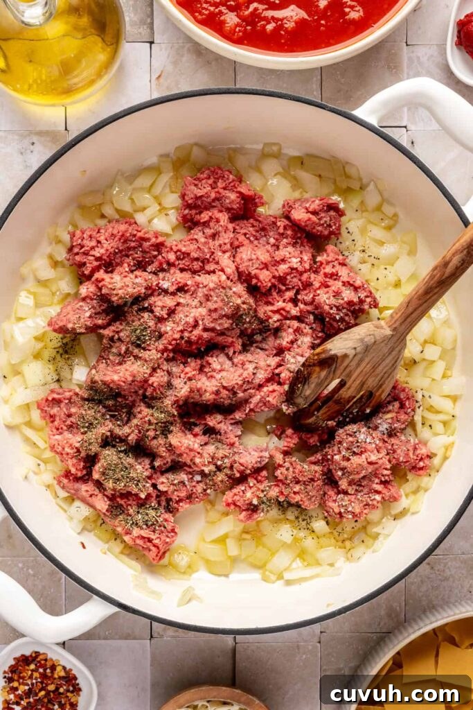 Browning the ground beef with the sautéed aromatics for lasagna soup including onions and garlic
