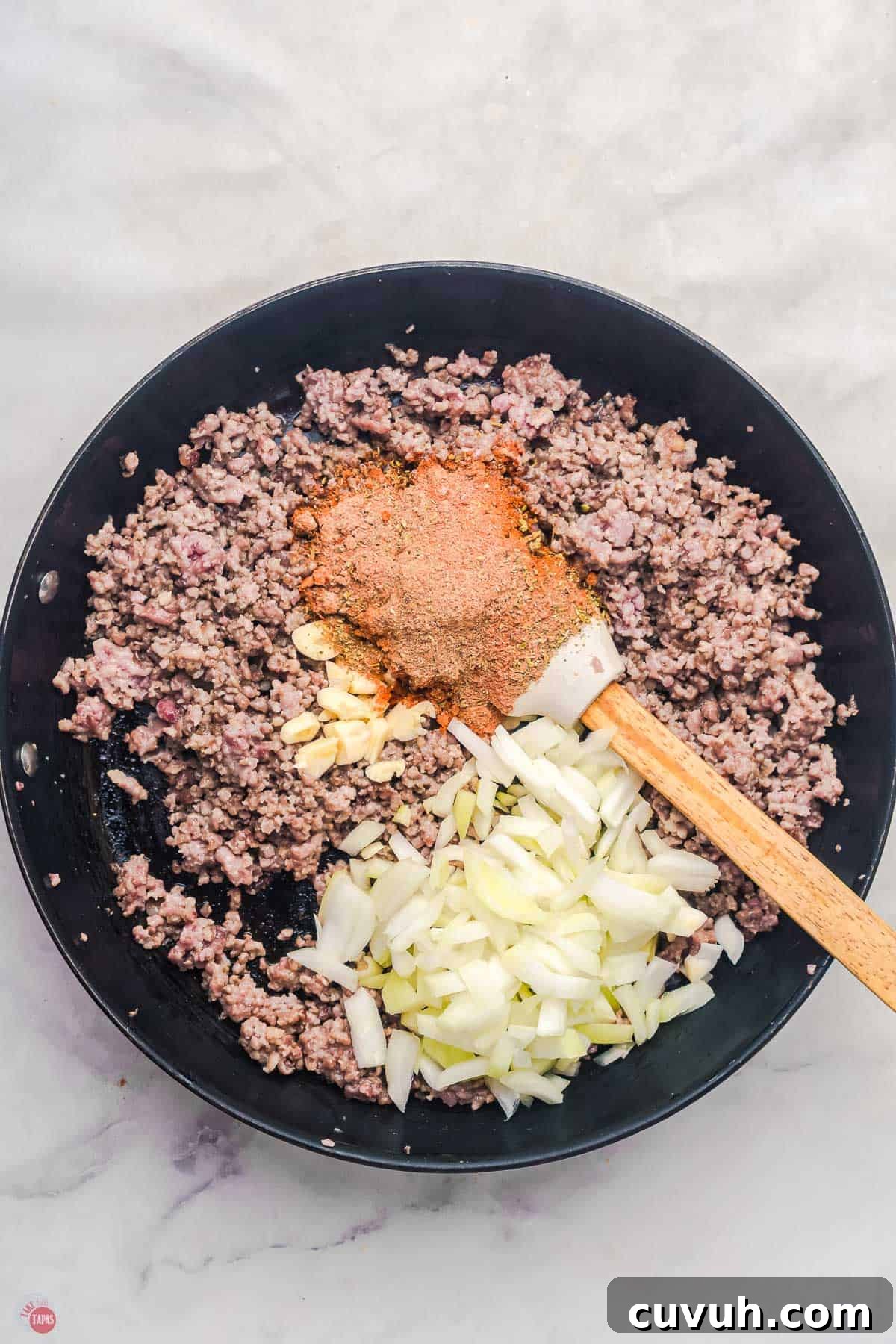ground beef and onions cooking in a skillet