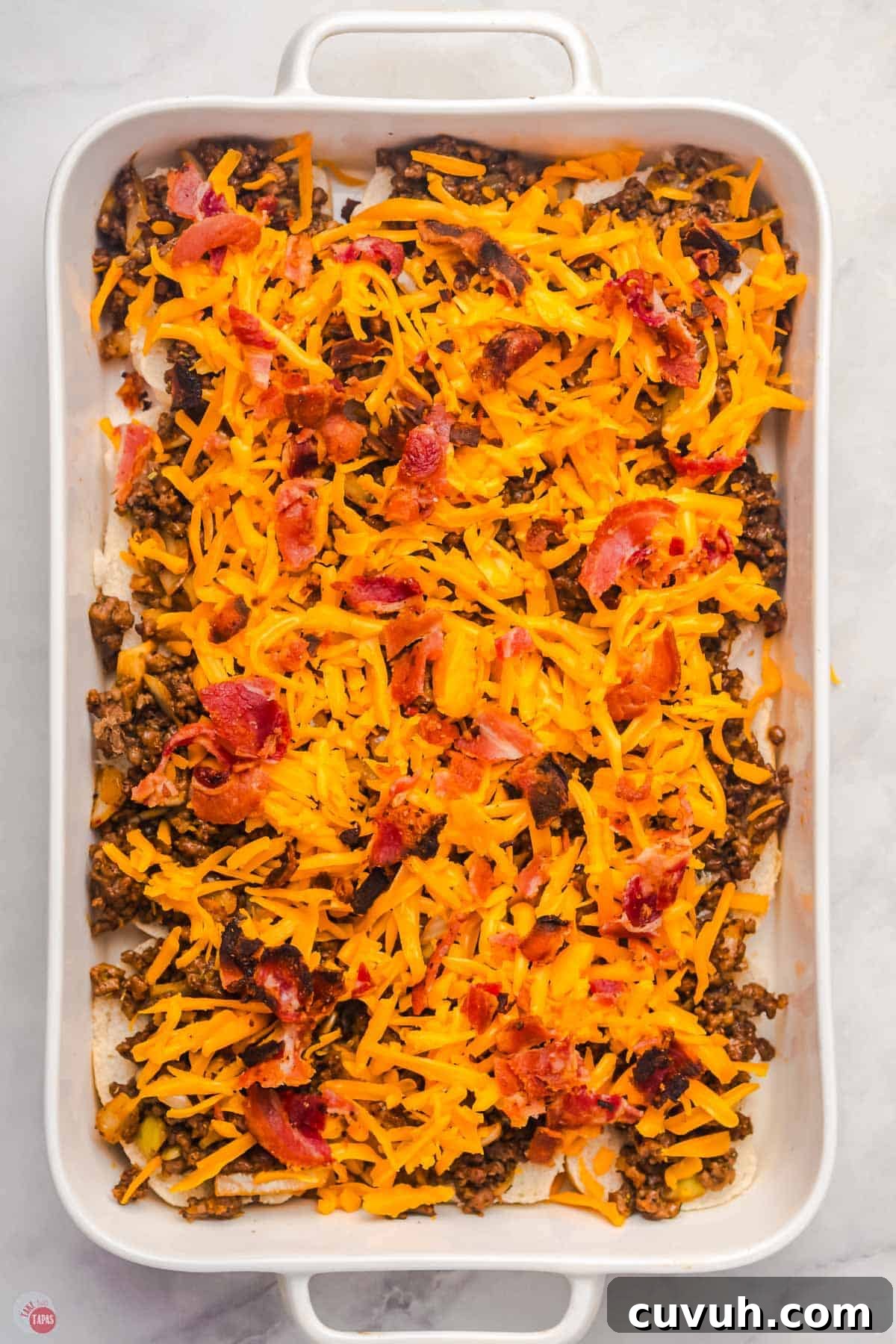slider buns topped with meat, cheese, and bacon.