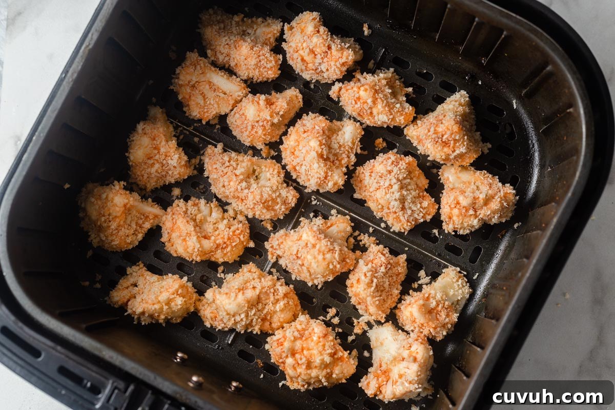 Crispy Air Fryer Buffalo Cauliflower Recipe 11 buffalo cauliflower in the air fryer basket.