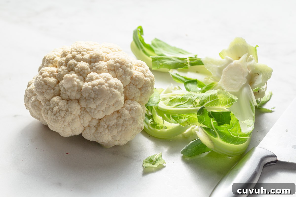 Crispy Air Fryer Buffalo Cauliflower Recipe 3 removing the outer leaves of cauliflower.