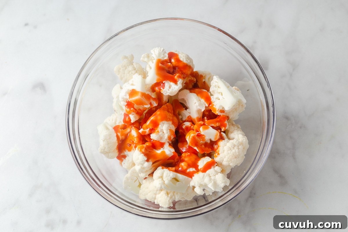 Crispy Air Fryer Buffalo Cauliflower Recipe 8 pouring the marinade to the cauliflower.