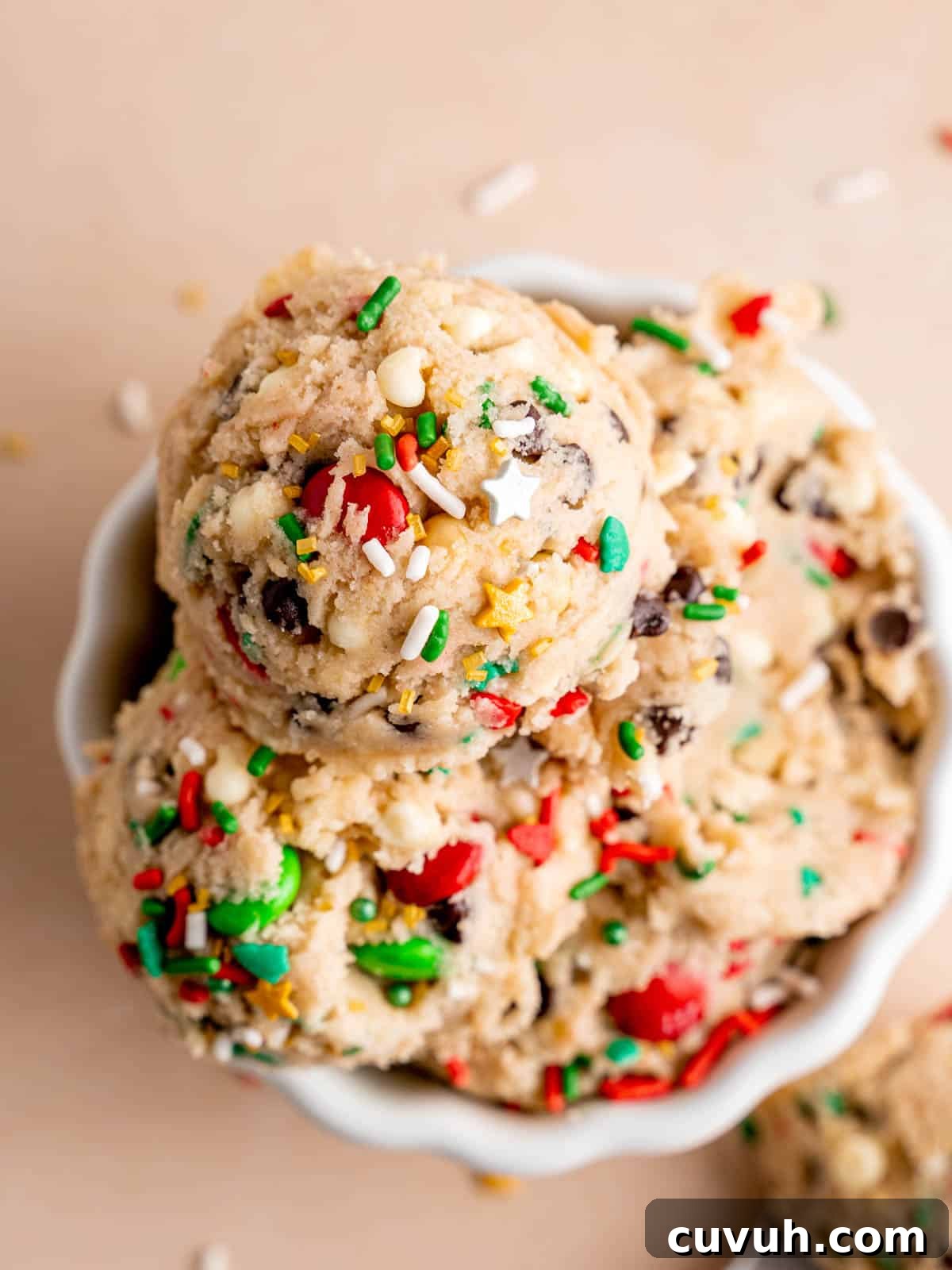 Edible chocolate chip cookie dough with holiday sprinkles and Christmas M&Ms.
