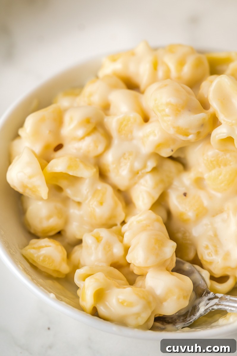 White cheddar macaroni and cheese in a white bowl.