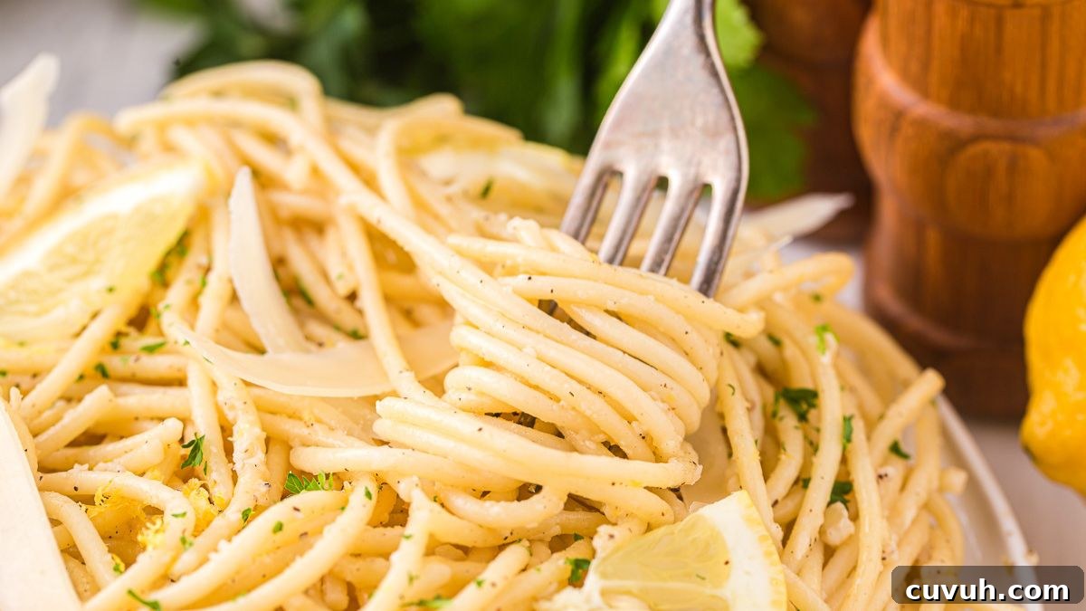 Lemon garlic parmesan pasta twirled on a fork.