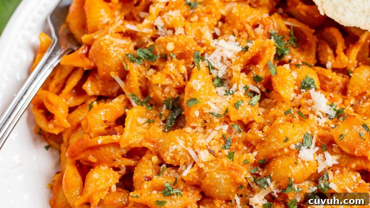 Spicy vodka pasta on a plate with a fork.