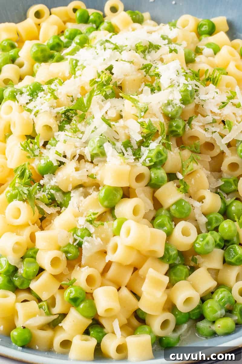 Pasta and peas in a blue bowl.