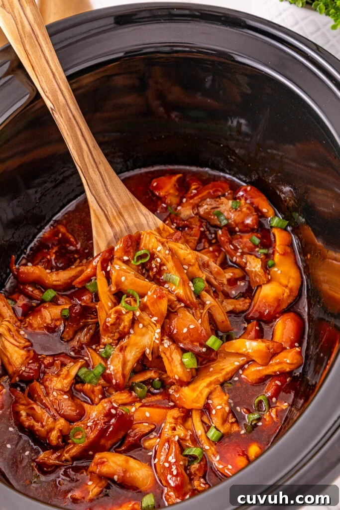 Crockpot honey garlic chicken in crockpot ready to be served.