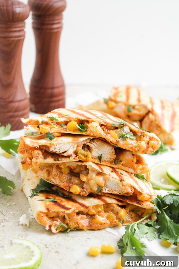 Street corn chicken quesadillas stacked on a plate.