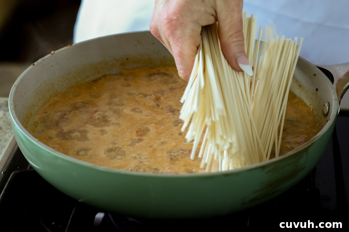 Creamy Tahini Ramen with Teriyaki Tofu (Nut-Free, One-Pan) 15 adding ramen noodles to the tahini broth