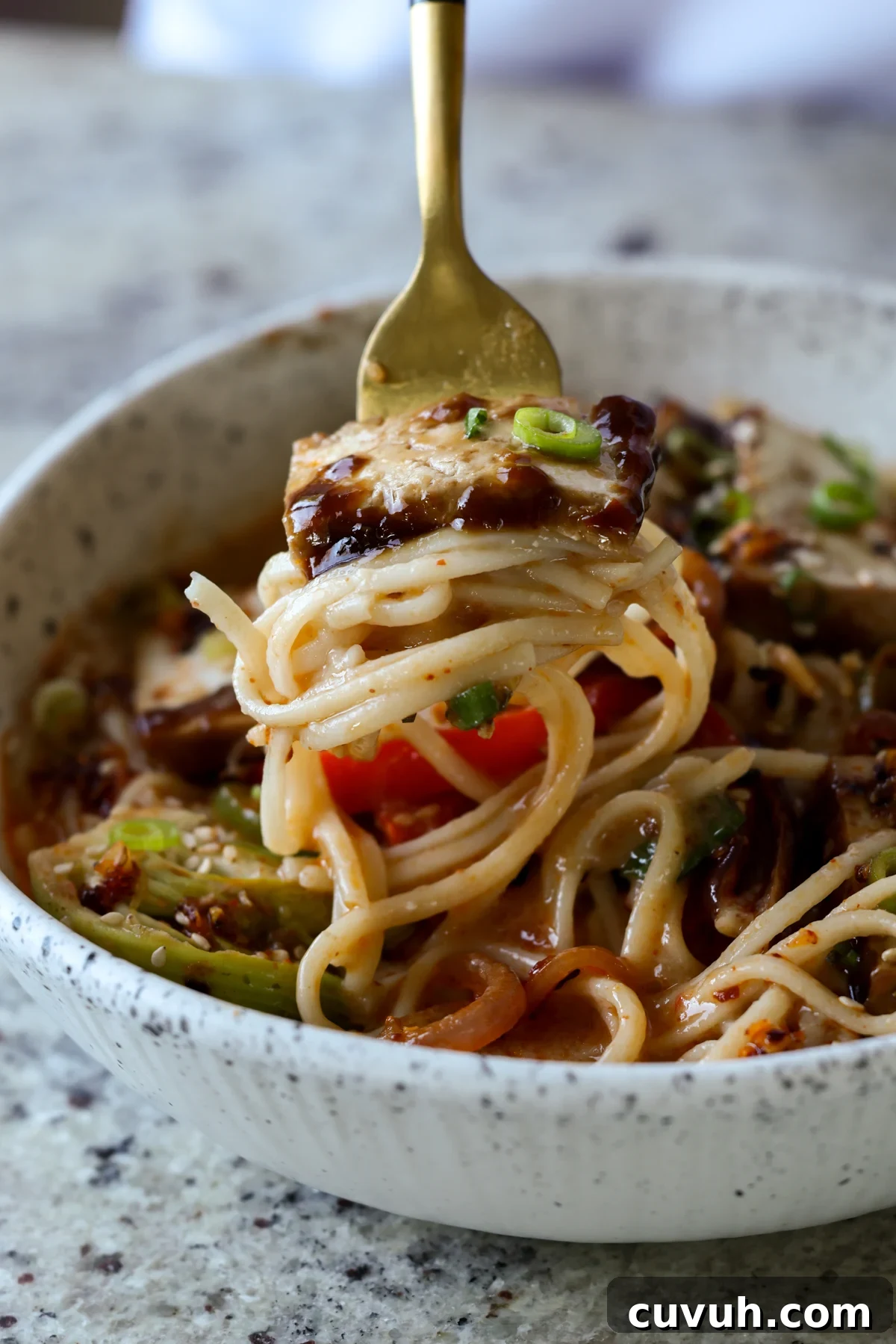 Creamy Tahini Ramen with Teriyaki Tofu (Nut-Free, One-Pan) 5 fork with a big bite of ramen noodles and tofu on it