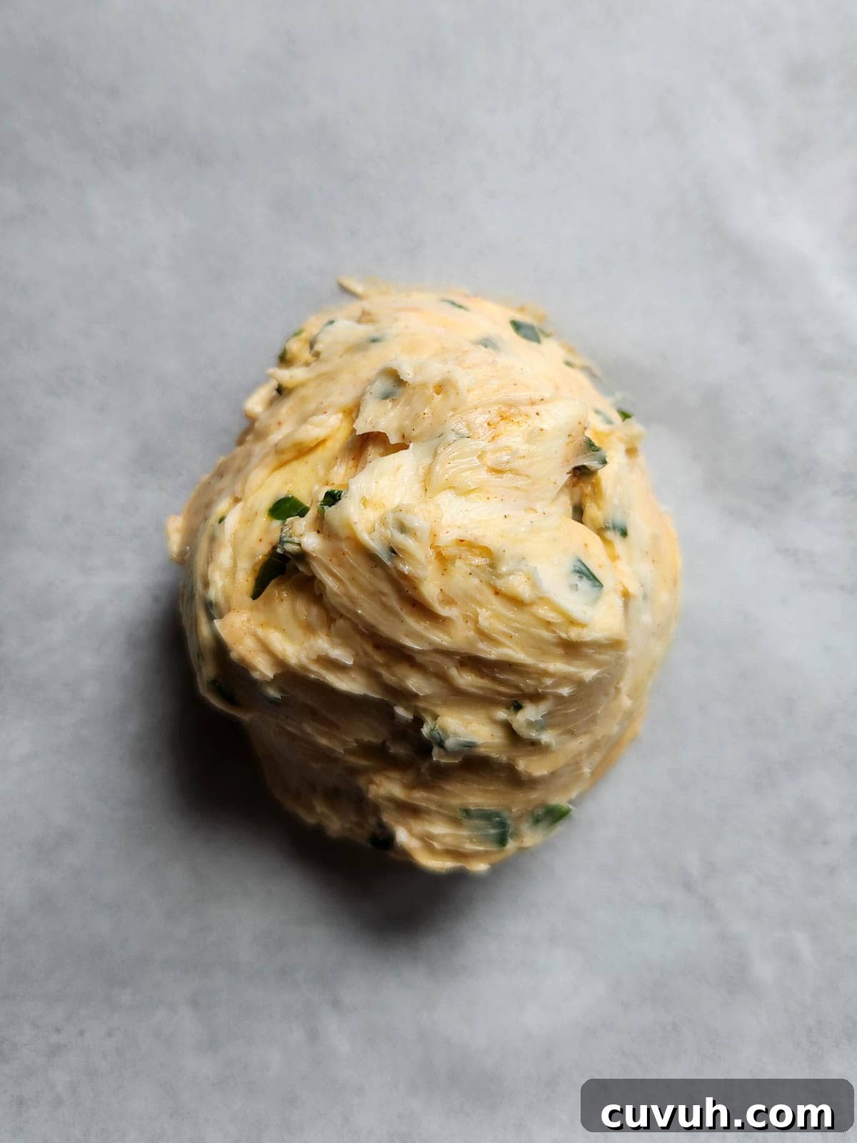 Smoked Chive Butter Recipe: Savory Compound Butter for Bread & Steak 6 Chive butter on parchment paper.
