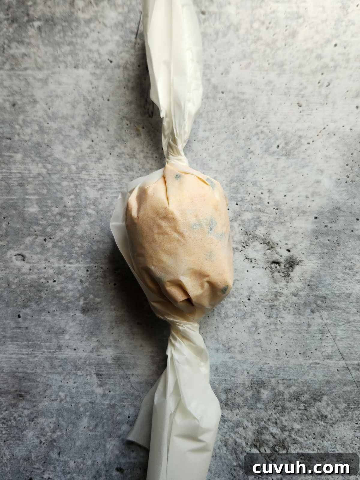 Smoked Chive Butter Recipe: Savory Compound Butter for Bread & Steak 7 Butter wrapped in parchment paper.