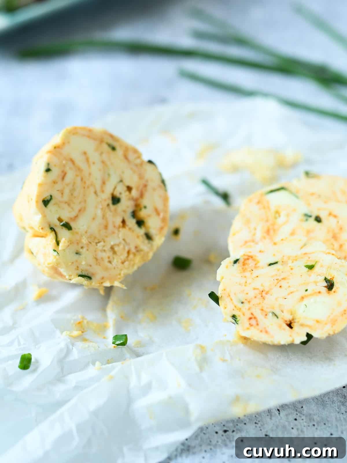 Smoked Chive Butter Recipe: Savory Compound Butter for Bread & Steak 8 A log of chive butter cut in half.