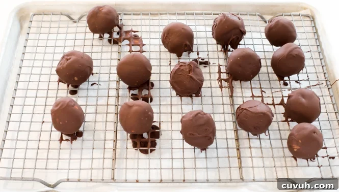 Chocolate dipped peanut butter pretzel truffles on wire rack