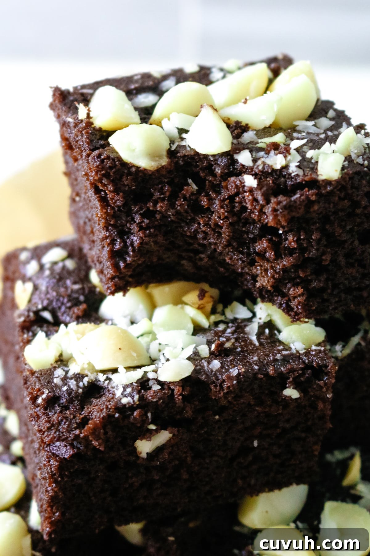 The coconut flour brownies are arranged on parchment paper.