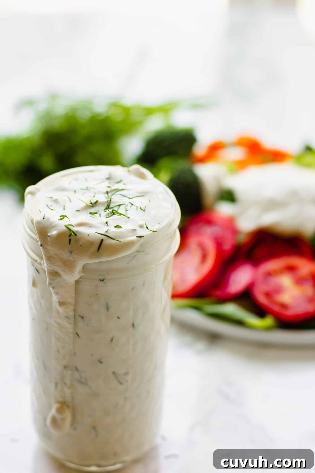 Creamy Vegan Ranch Dressing Recipe for Salads & Dips 5 close up on a glass jar filled with vegan ranch dressing.