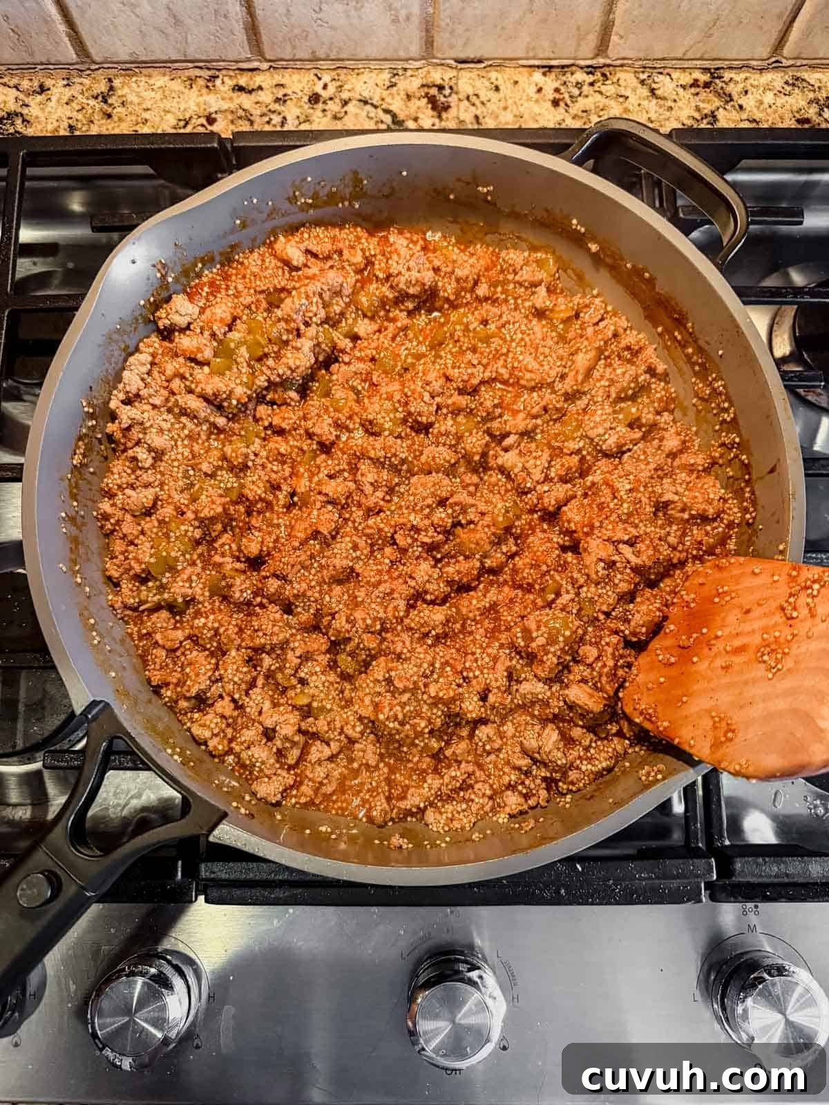 cooked ground turkey, quinoa, enchilada sauce, and chicken broth after simmering on the stove.