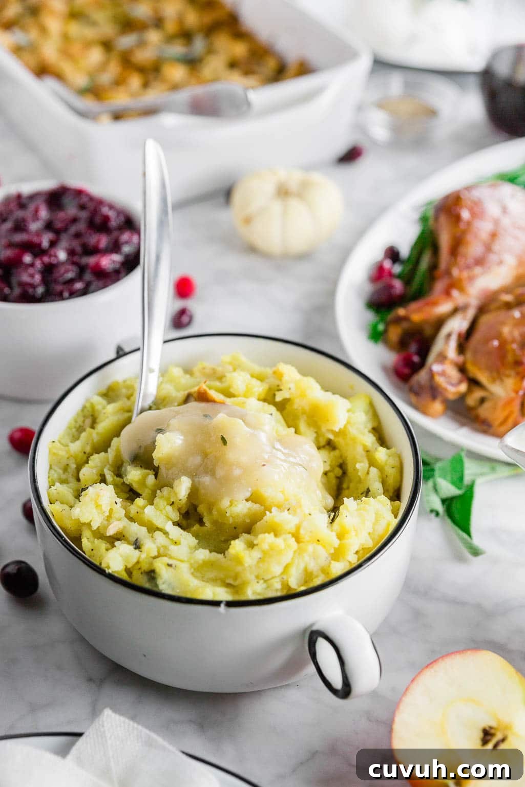 Roasted Garlic Mashed Potatoes with Brown Butter & Sage 4 A gluten-free thanksgiving table with roasted garlic mashed potatoes, turkey, stuffing and cranberry sauce.