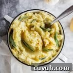 Roasted Garlic Mashed Potatoes with Brown Butter & Sage 6 A bowl of roasted garlic mashed potatoes with brown butter and fresh sage leaves.