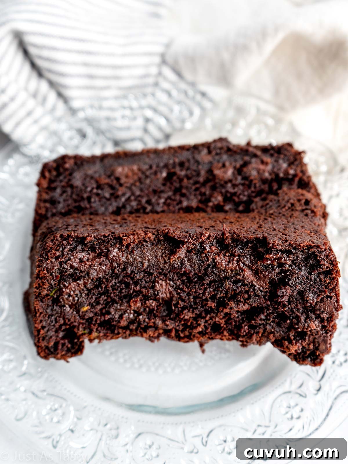 Ultra-Moist Double Chocolate Zucchini Bread — Gluten-Free & Eggless 4 Two slices of chocolate zucchini bread on a plate.