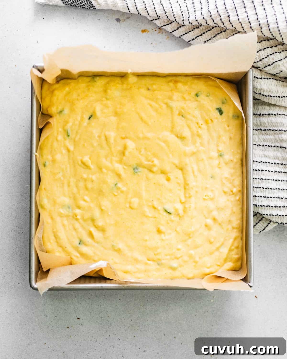Spicy Jalapeño Honey Cornbread Recipe 7 cornbread batter in square baking dish.