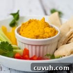 Roasted Carrot Dip in a ramekin with veggie sticks