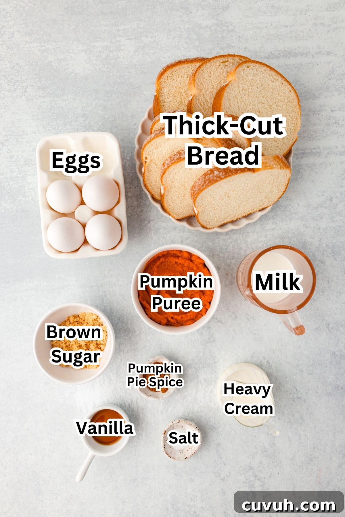 Ingredients for pumpkin French toast arranged on a light surface.