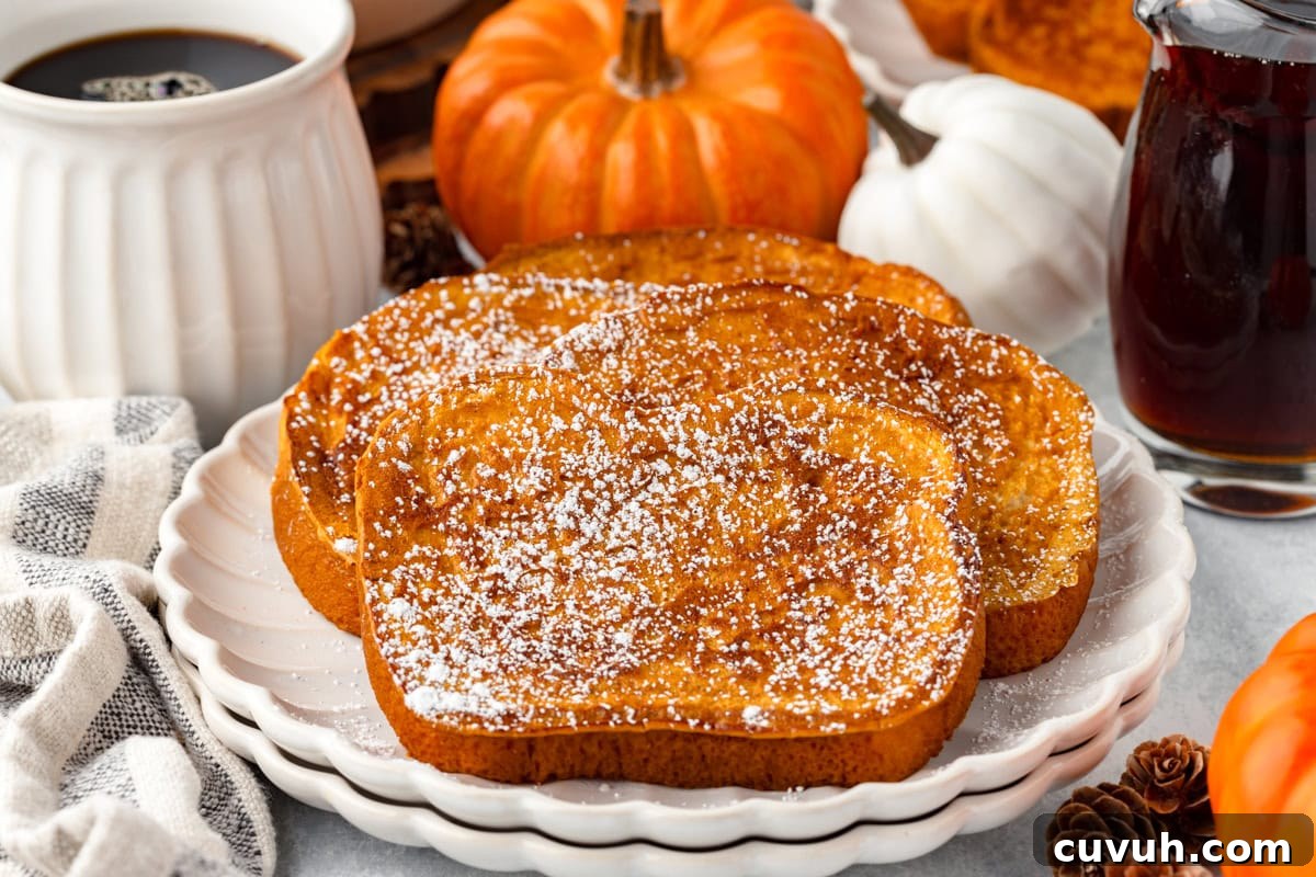 Two slices of pumpkin French toast on white plates.