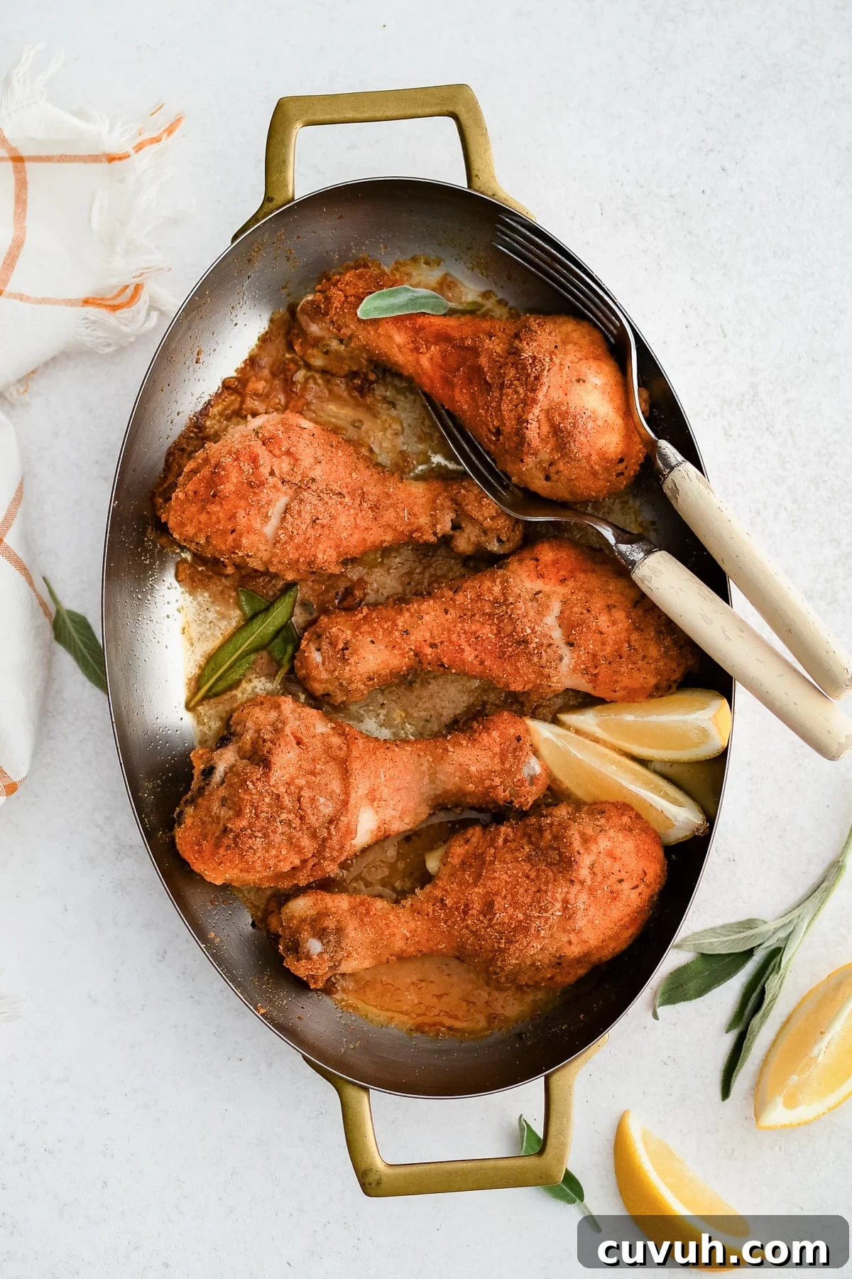 Crispy Shake-and-Bake Chicken Recipe for Perfect Weeknight Meals 2 Oval-shaped baking dish filled with five golden, crispy baked chicken drumsticks coated in shake and bake seasoning.