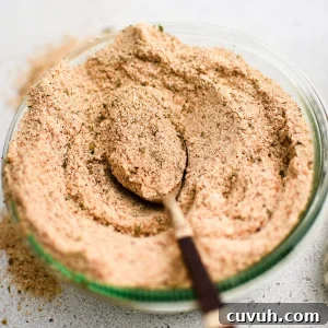 Crispy Shake-and-Bake Chicken Recipe for Perfect Weeknight Meals 3 Glass jar filled with homemade Shake and Bake seasoning with a spoon set on top.