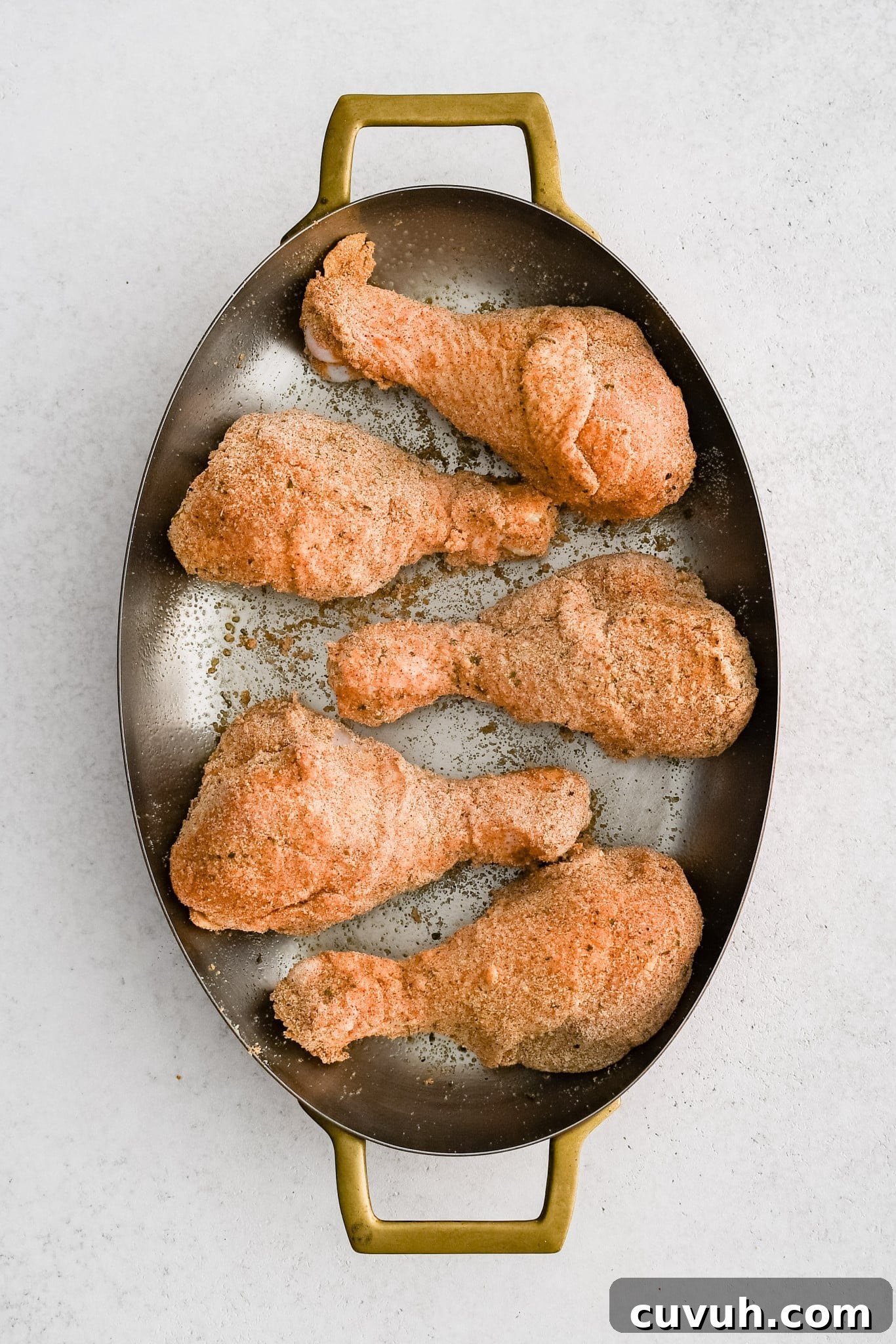 Crispy Shake-and-Bake Chicken Recipe for Perfect Weeknight Meals 10 Baking dish filled with five large chicken drumsticks coated in homemade shake and bake seasoning.
