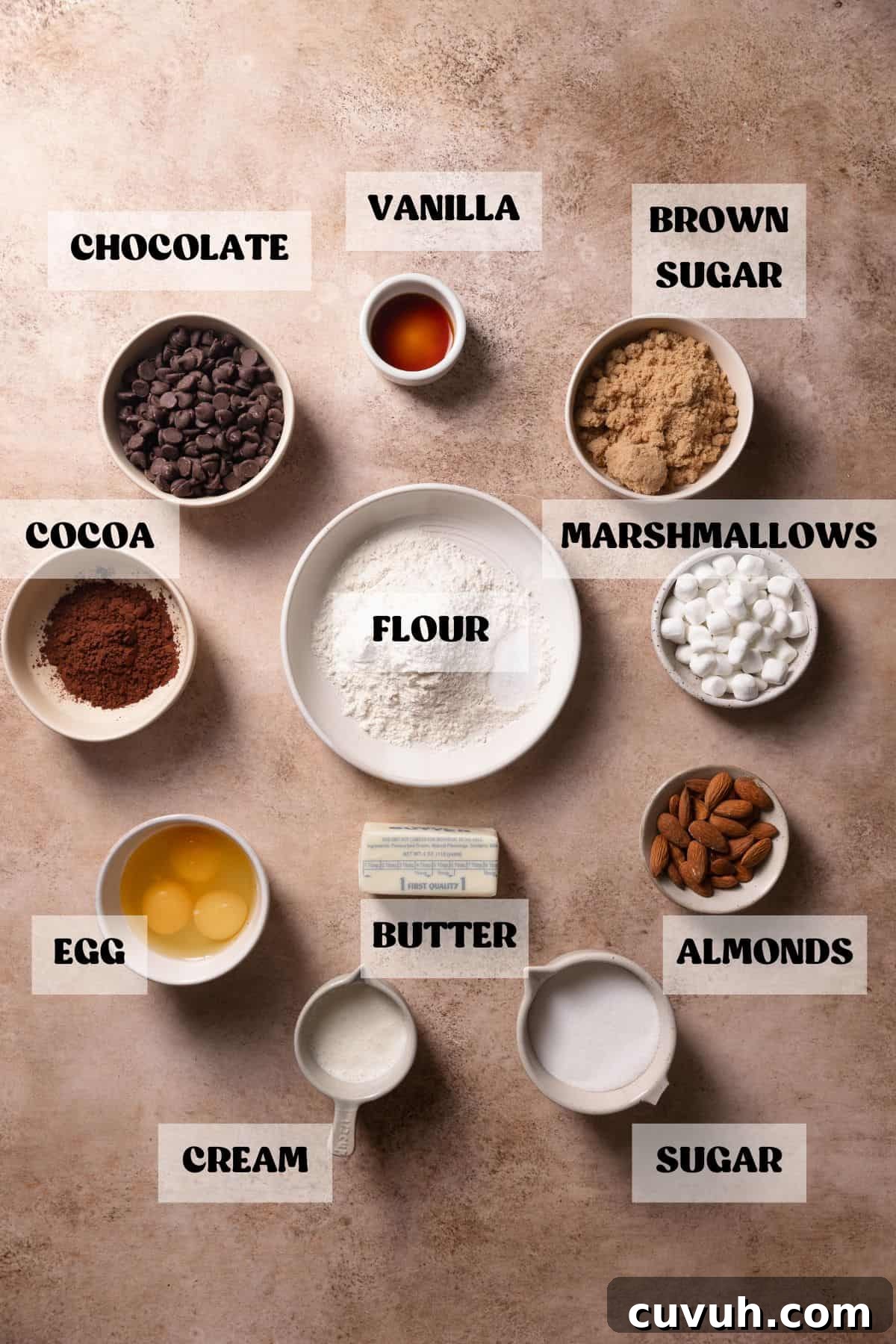 Ingredients needed to make brownies with marshmallows and almonds in bowls with labels.