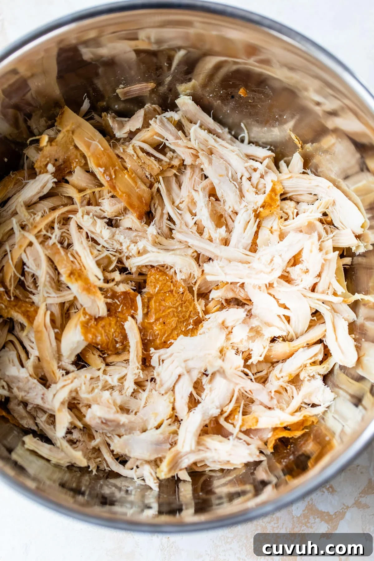 shredded chicken in a large mixing bowl