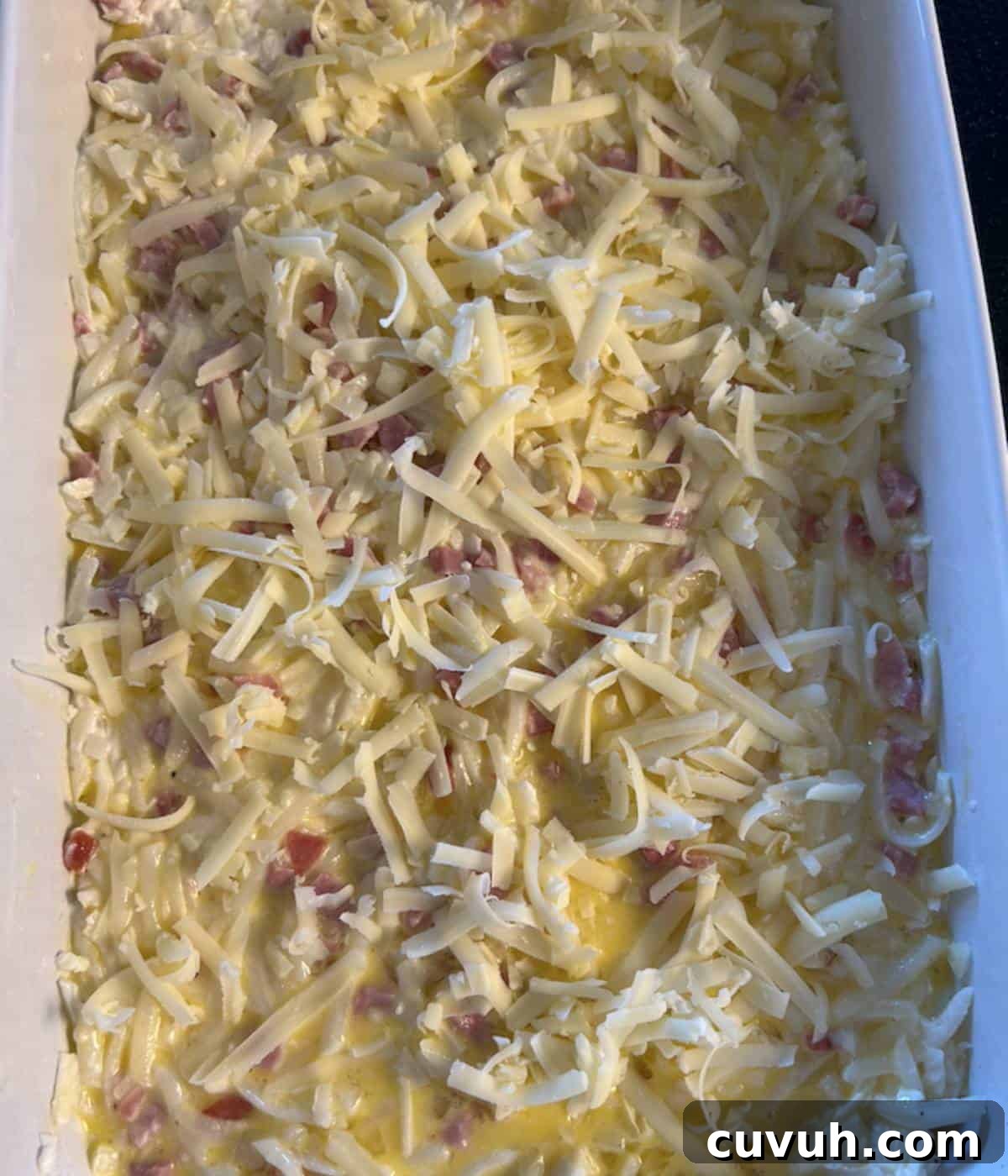 Breakfast Casserole with cheese ready to bake.