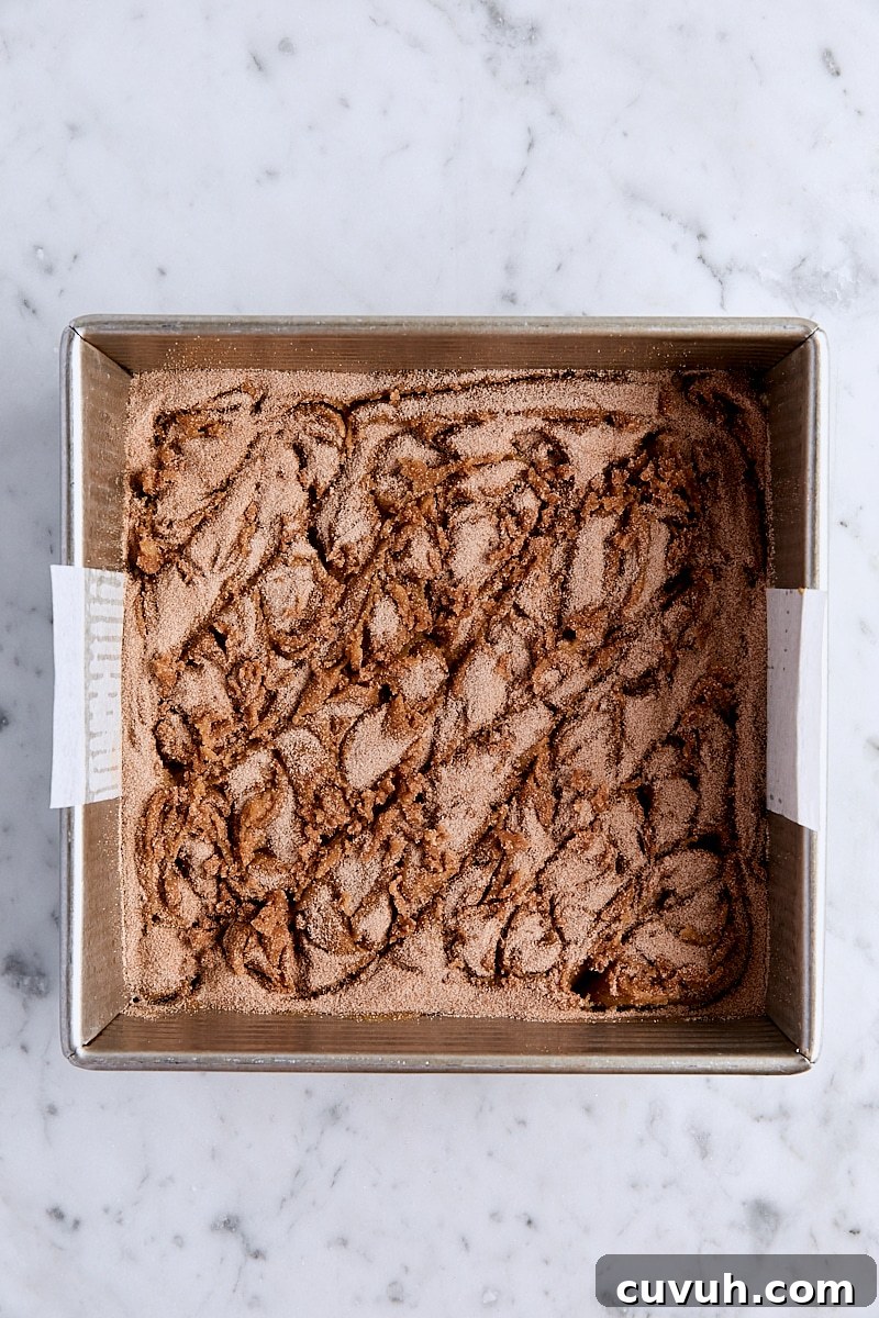 Cinnamon-sugar swirled into blondie batter in parchment-lined square pan