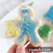 Gingerbread boy decorated with blue sprinkles.