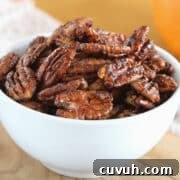 Glazed pecans in a white bowl.