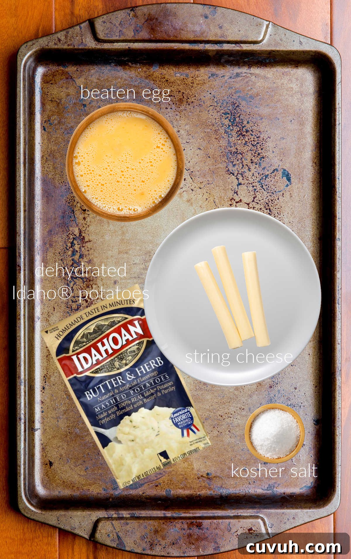 Collage of ingredients for making fried cheese sticks, laid out on a sheet pan.
