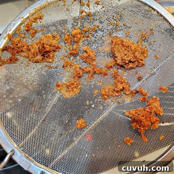 Skimmer with breading on it from the fryer.