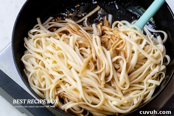 Tossing noodles with sauce
