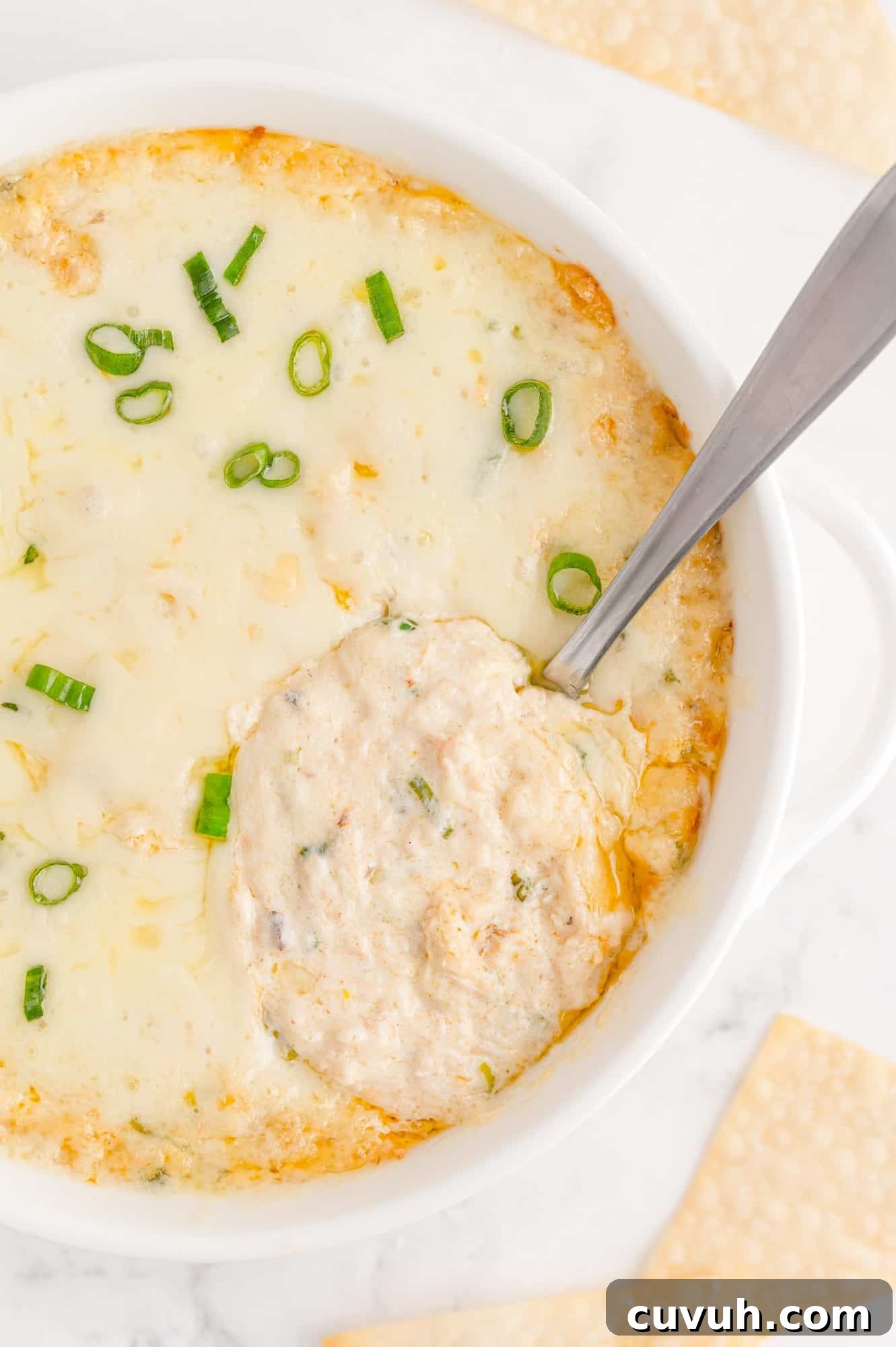 Crab rangoon dip with spoon to show texture.