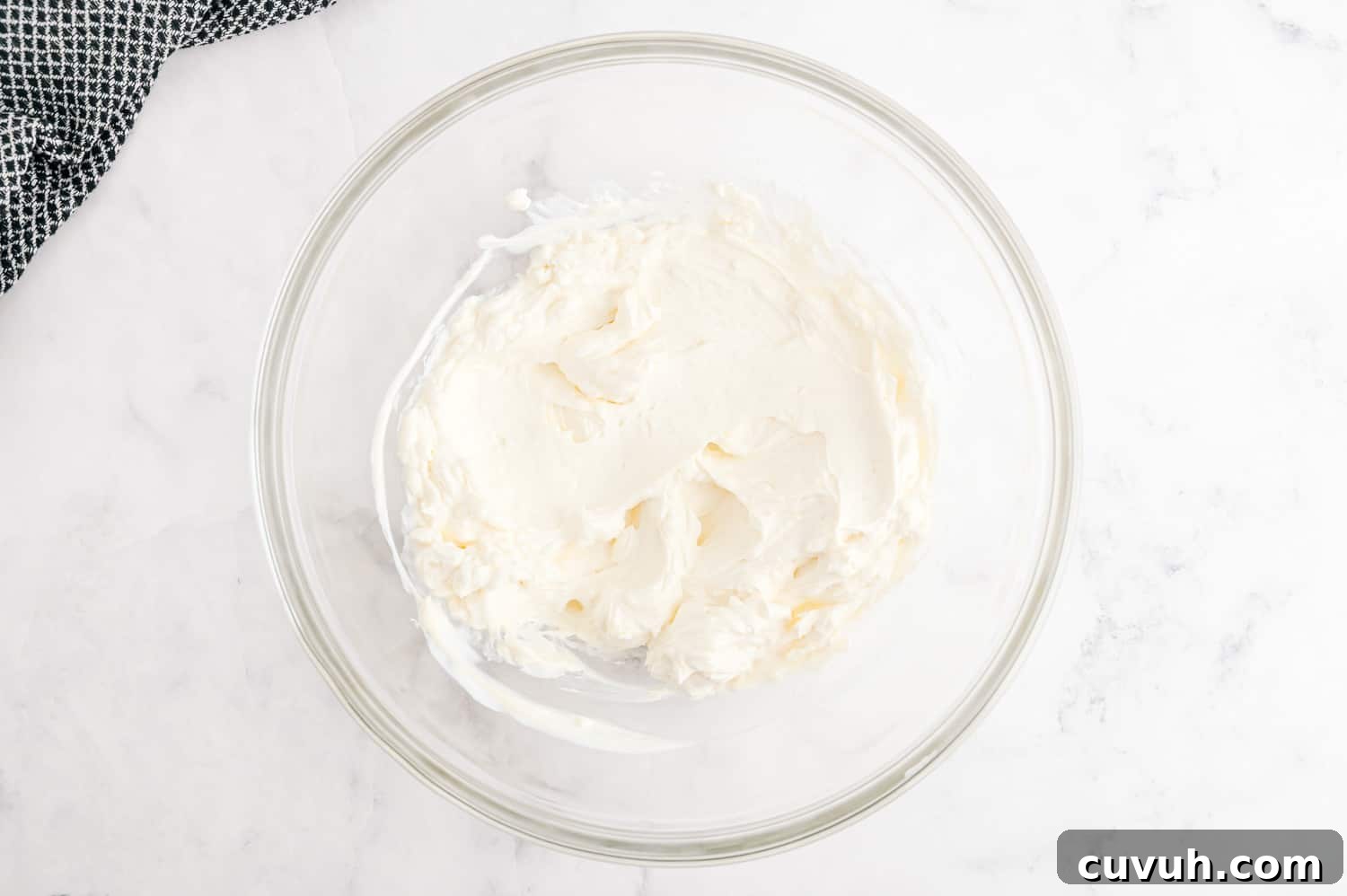 Creamy ingredients in a glass mixing bowl.