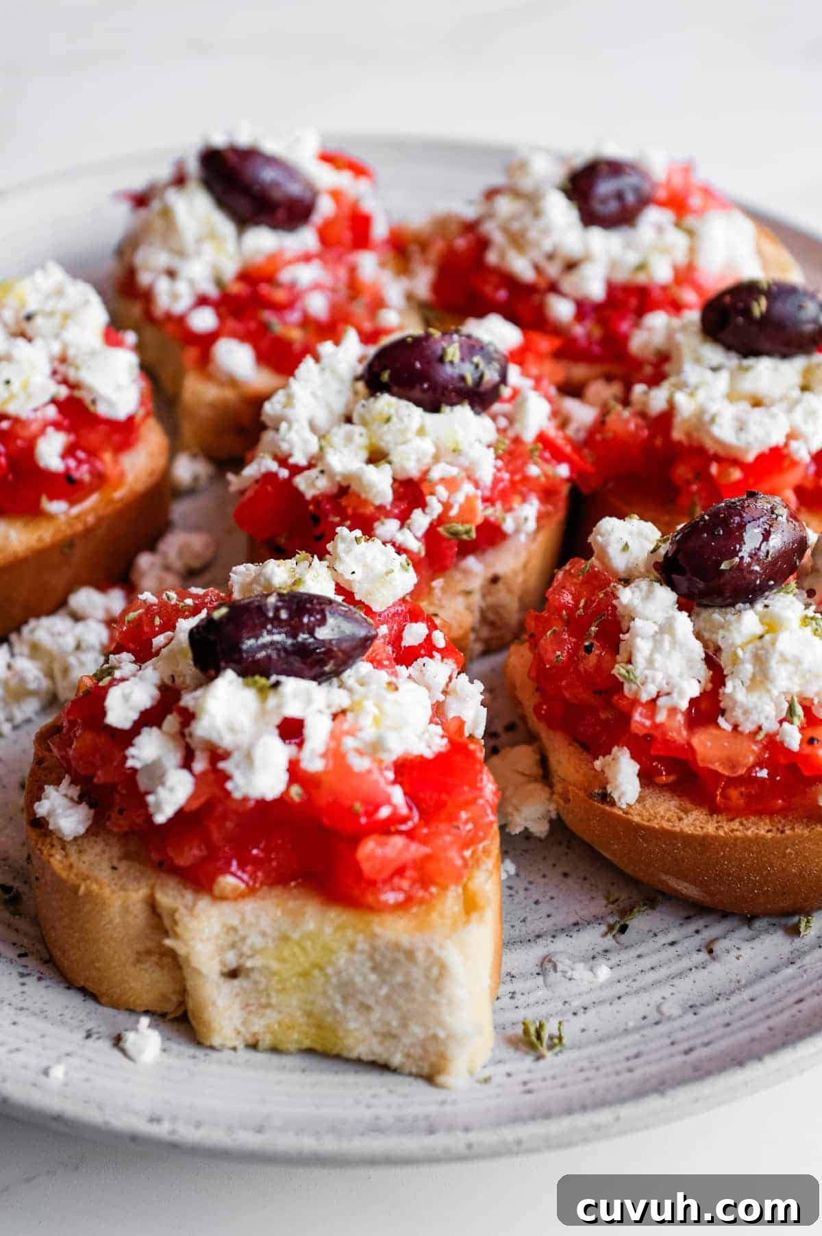 Crisp barley rusks loaded with juicy tomato and salty feta cheese