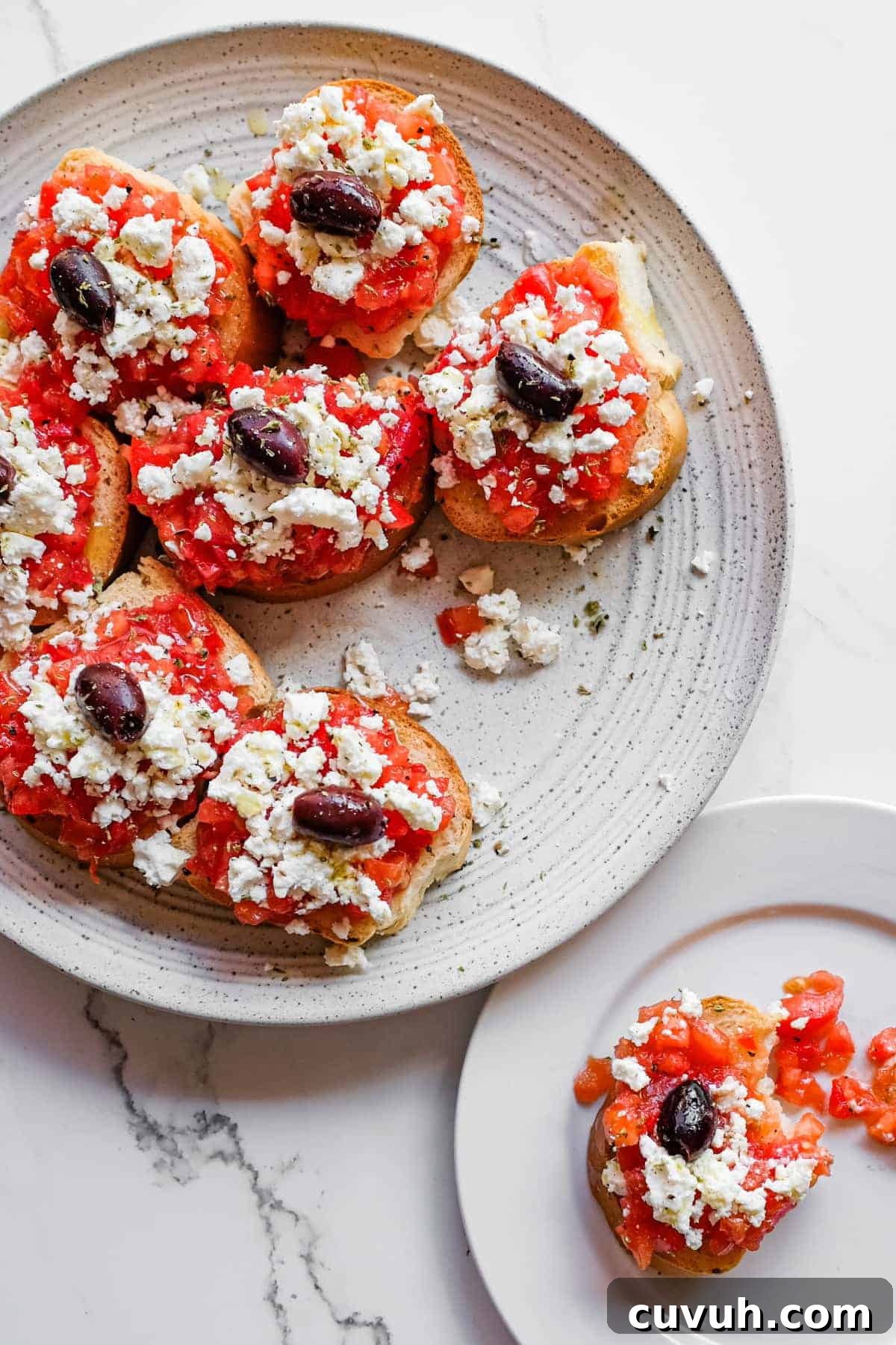 Authentic Cretan dakos served on a rustic platter with olives and oregano