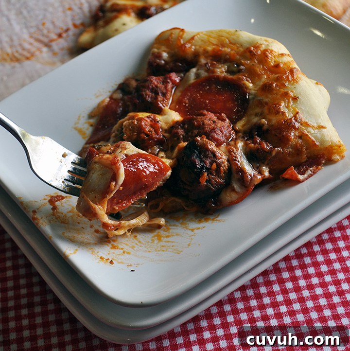 Homemade pizza with meatballs and pepperoni.
