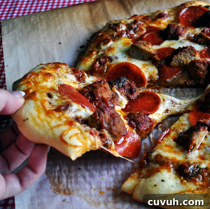 Homemade pizza with meatballs and pepperoni.